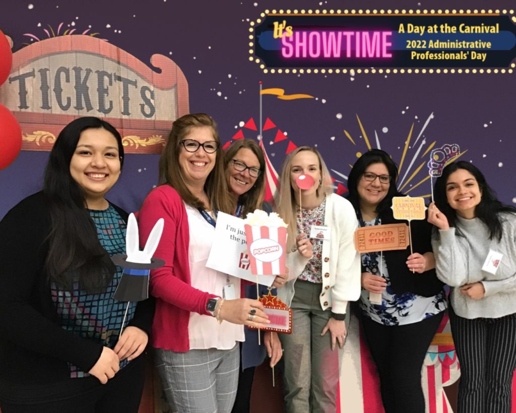 Six ladies from Admin Pro 2022 posing with props