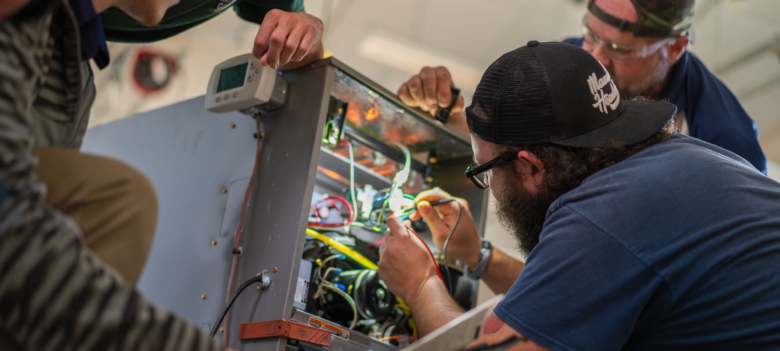 men working on hvac system