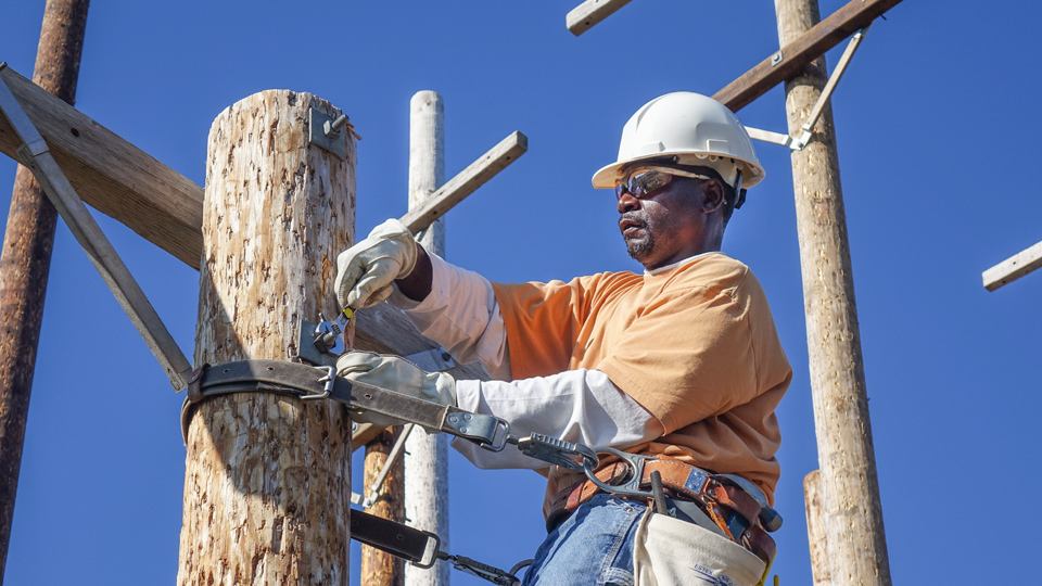 man on the job as a power line worker