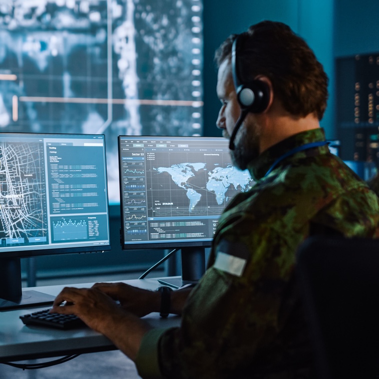 Information Security Analyst a man sitting in front of several computer monitors