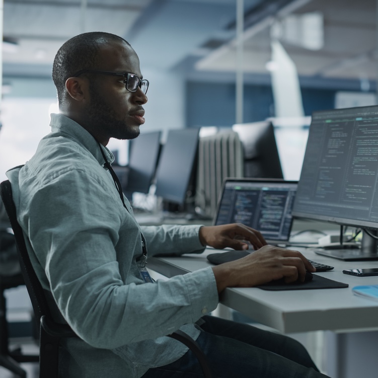 Software Developer a man types on a computer keyboard